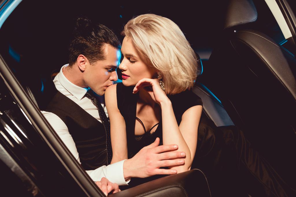 stock photo handsome stylish man embracing kissing fashionable young woman car
